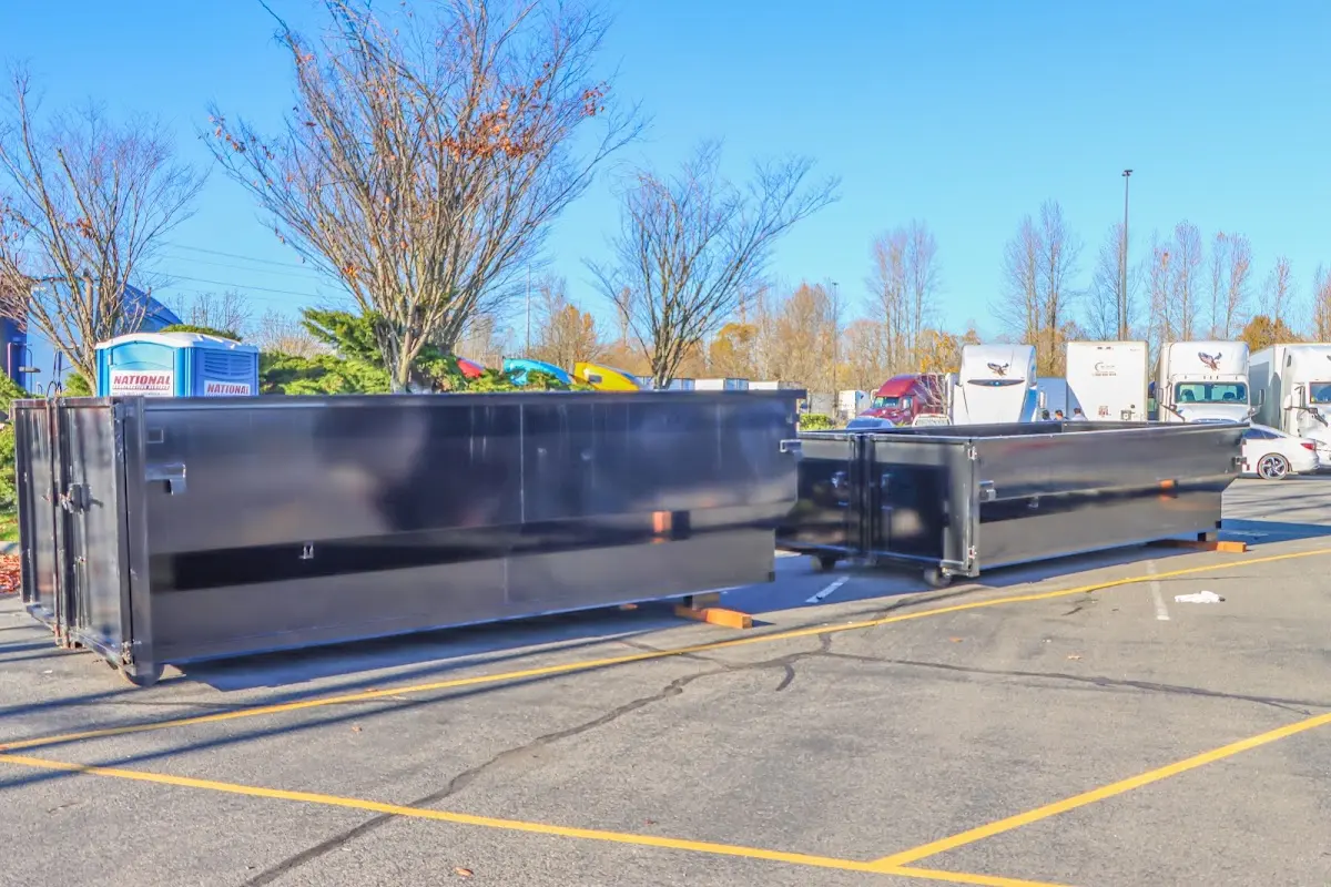 Professional dumpster rental service with roll-off container on residential driveway in Conover